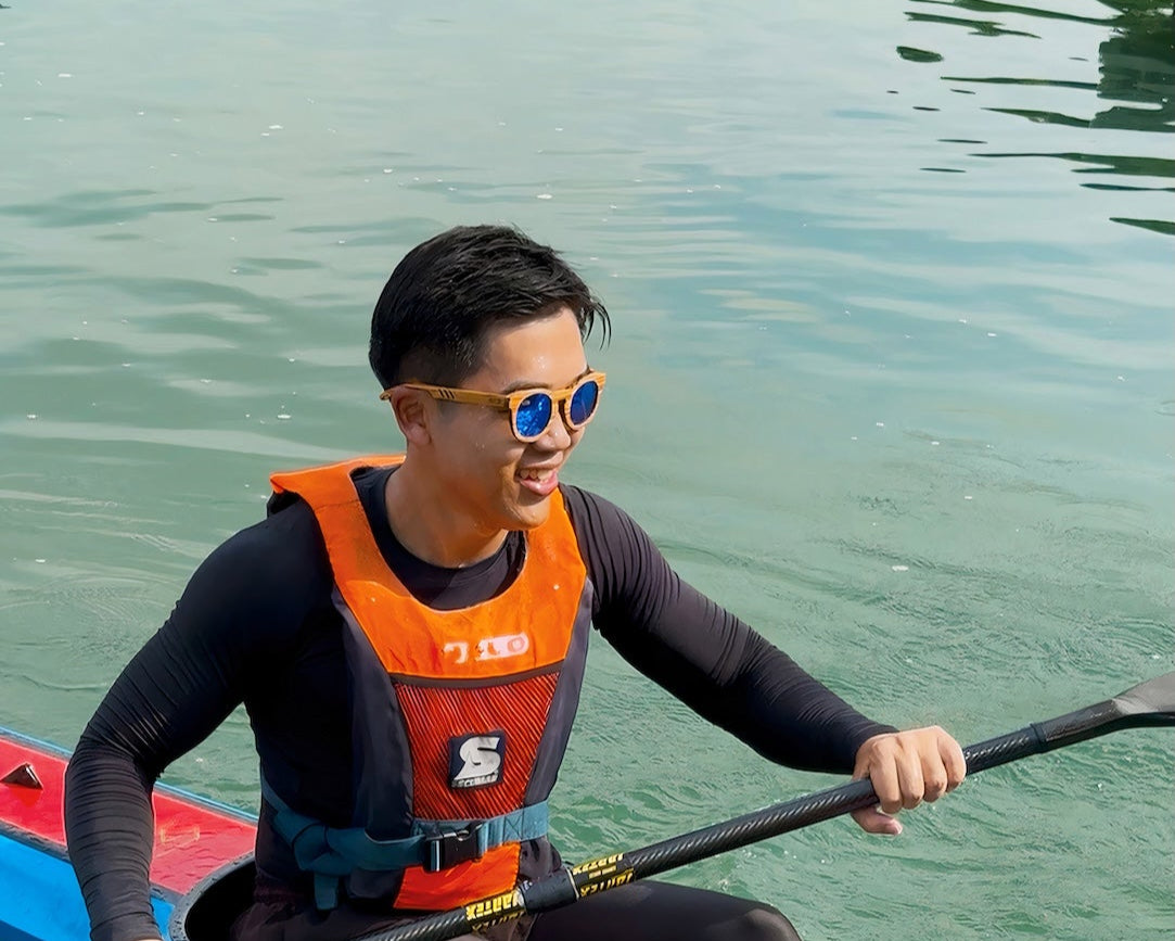 Man kayaking while wearing MoovWave Glacier blue polarized wooden sunglasses, floatable and waterproof sunglasses for kayaking and outdoor water sports in Singapore